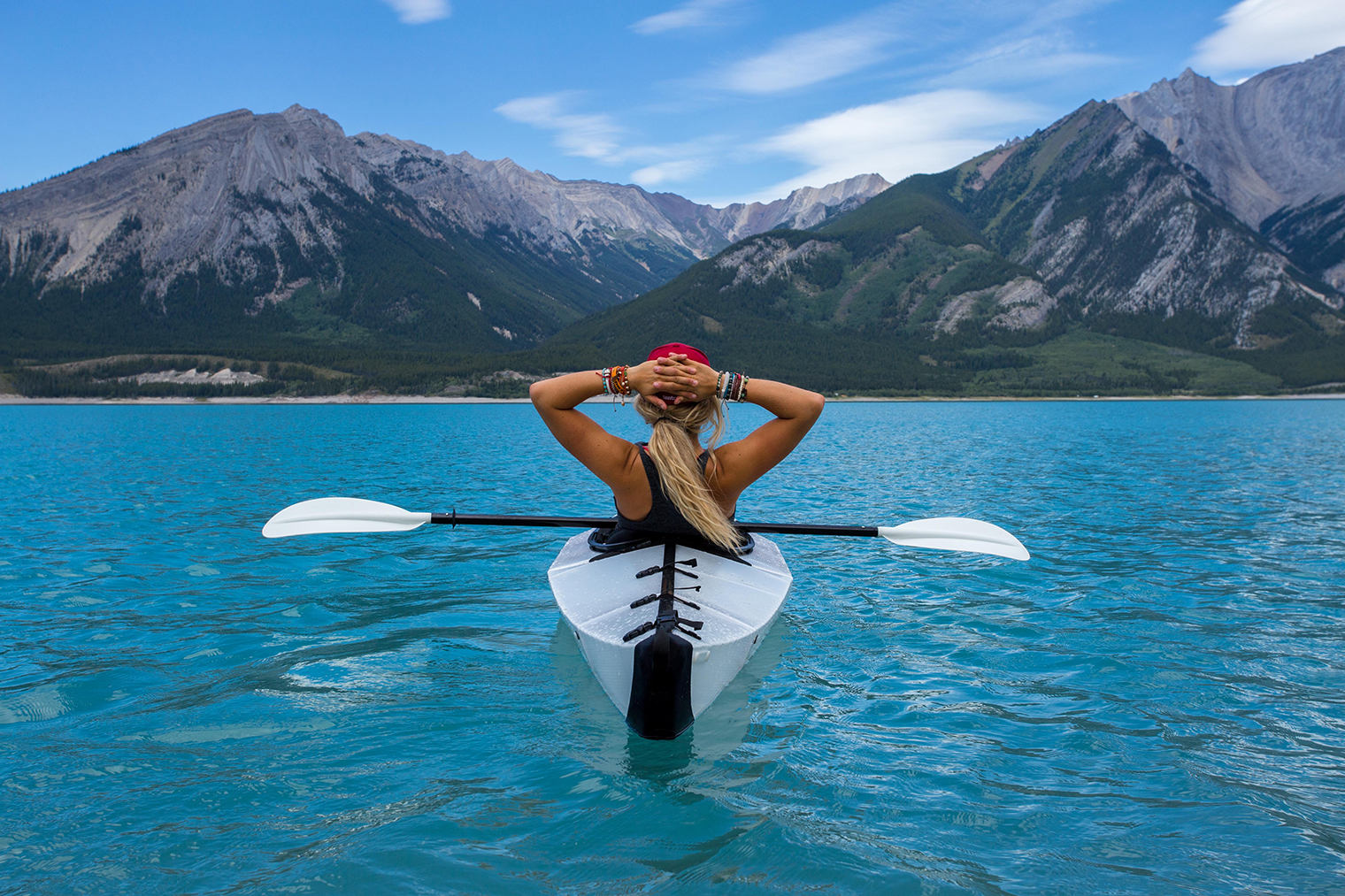 Woman in kayak on a mountain lake